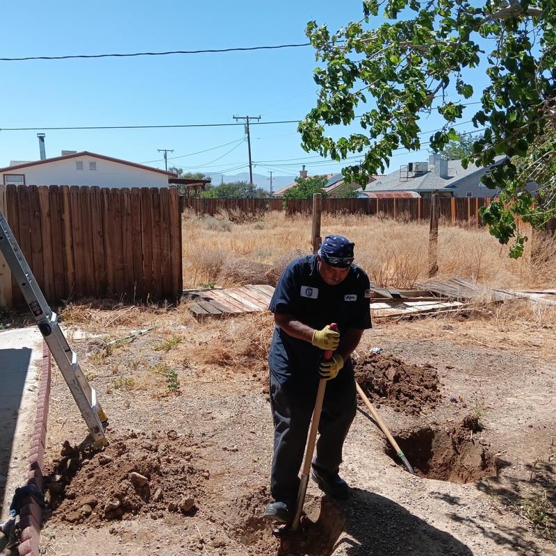 Concrete septic tank riser installation in yard