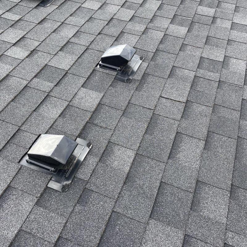 Roof flapper vents on gray asphalt shingles