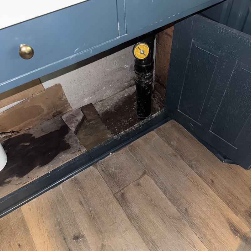 Sewer cleanout pipe with pressure test gauge under cabinet Sewer cleanout pipe with pressure test gauge under cabinet