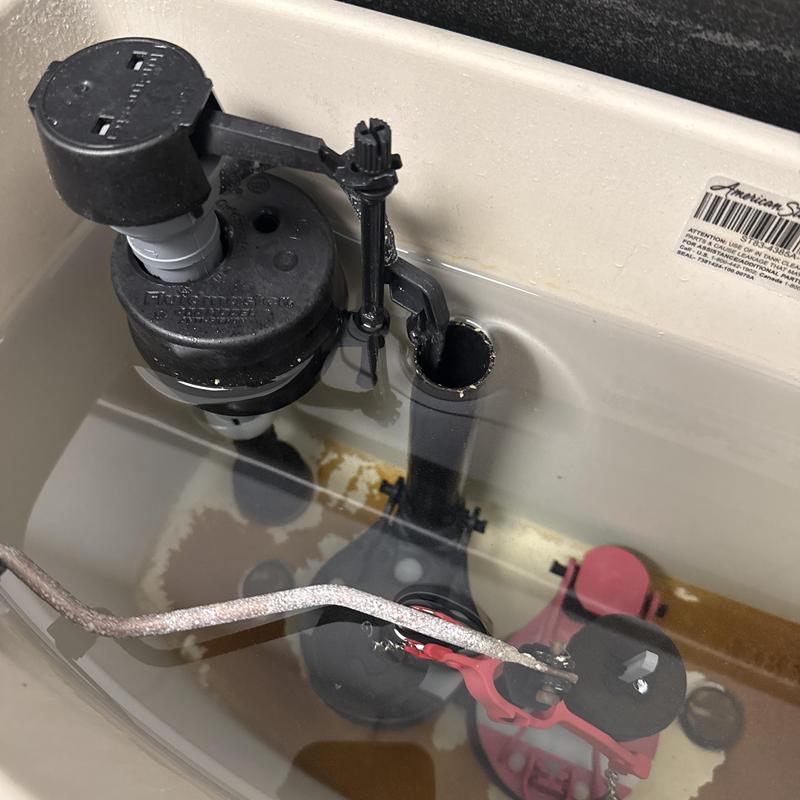 Toilet fill valve and flapper inside tank