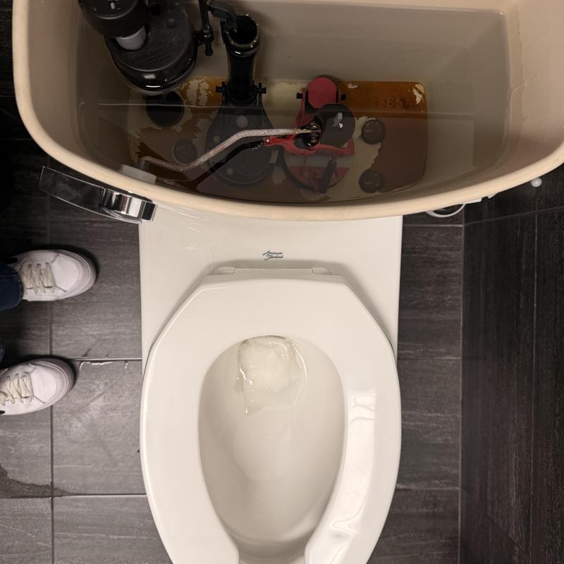 Toilet fill valve inside tank with open lid