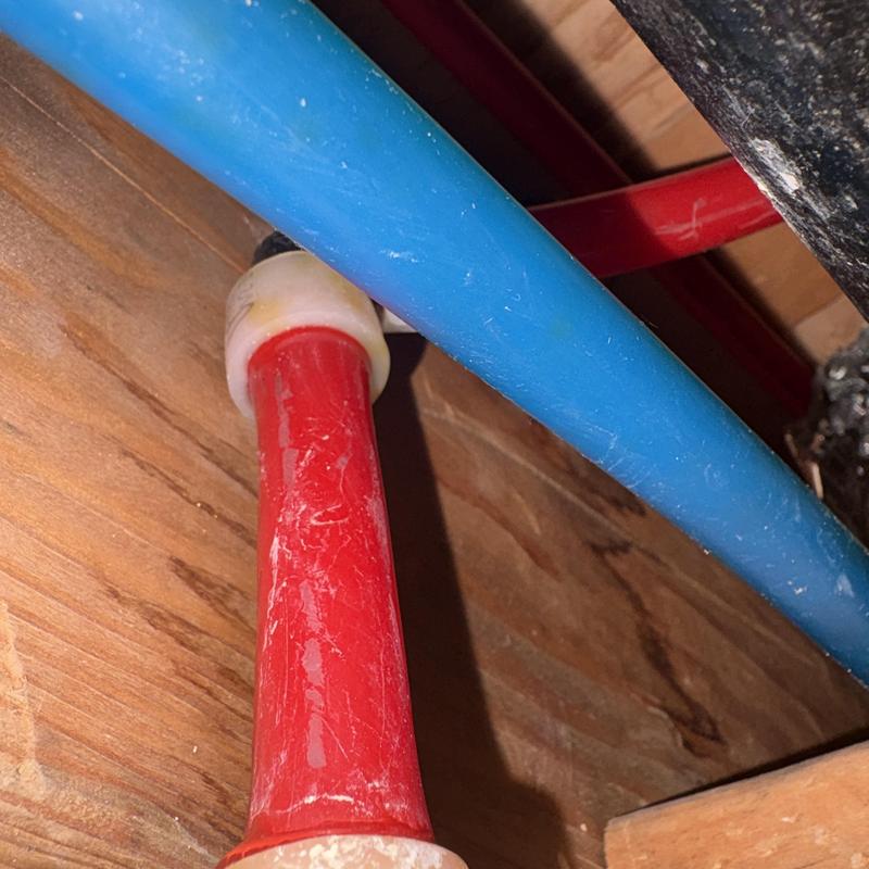 PEX water line with red and blue pipes in ceiling
