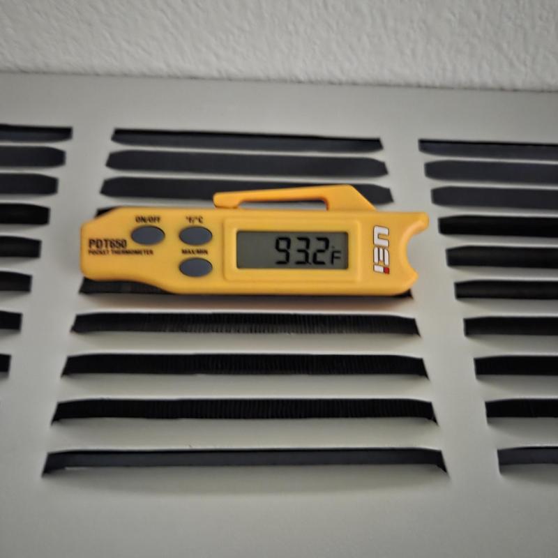 HVAC air vent with digital thermometer reading HVAC air vent with digital thermometer reading