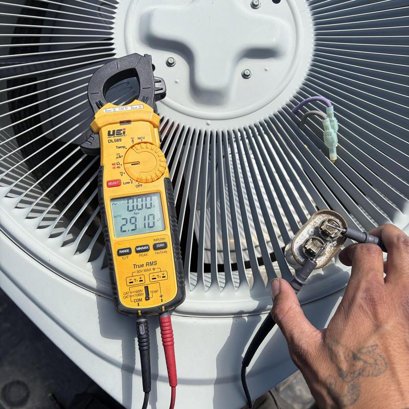Air conditioner capacitor testing with multimeter during maintenance Air conditioner capacitor testing with multimeter during maintenance