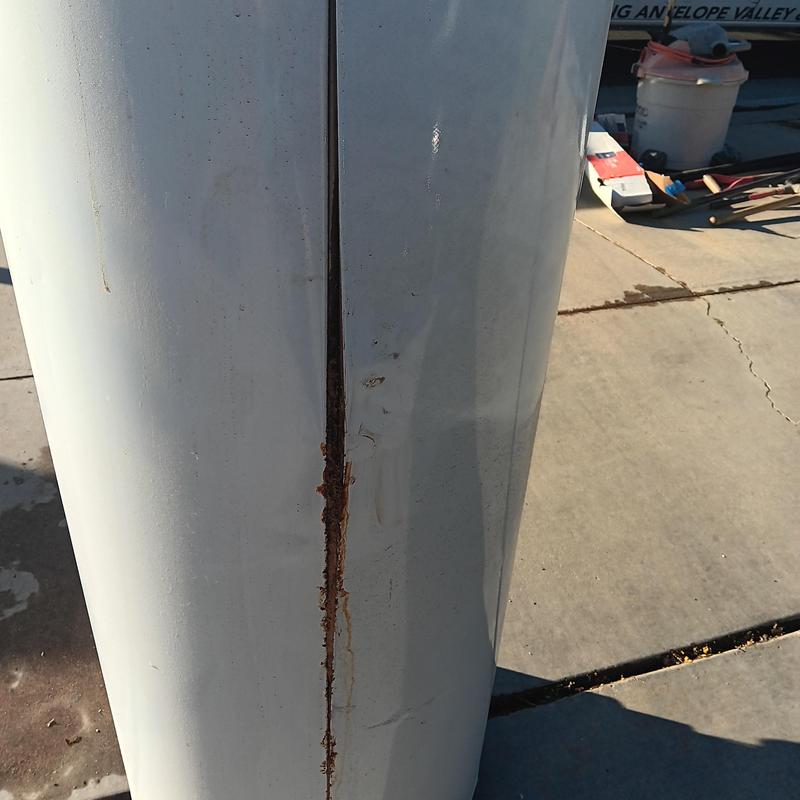 Natural gas water heater with rusted burst seam