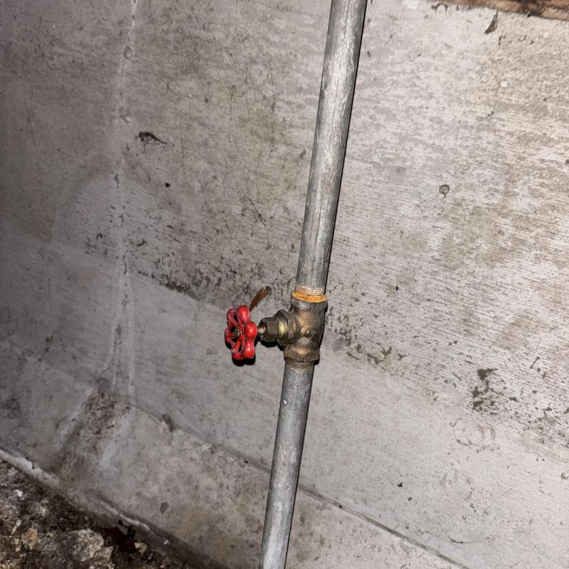Angle stop valve on water supply pipe in basement Angle stop valve on water supply pipe in basement