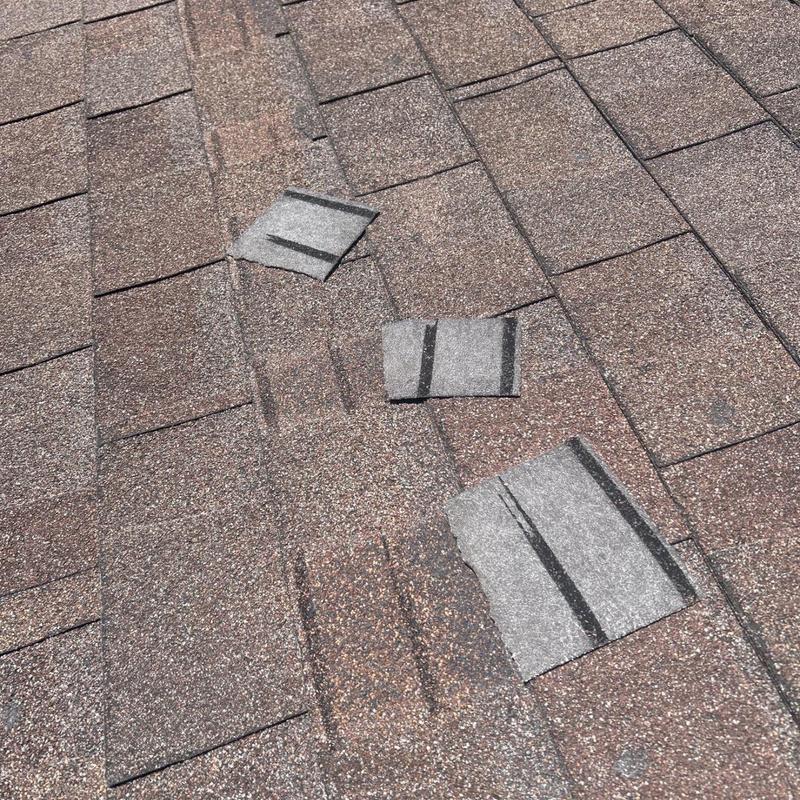 Shingle roof with damaged and missing shingles