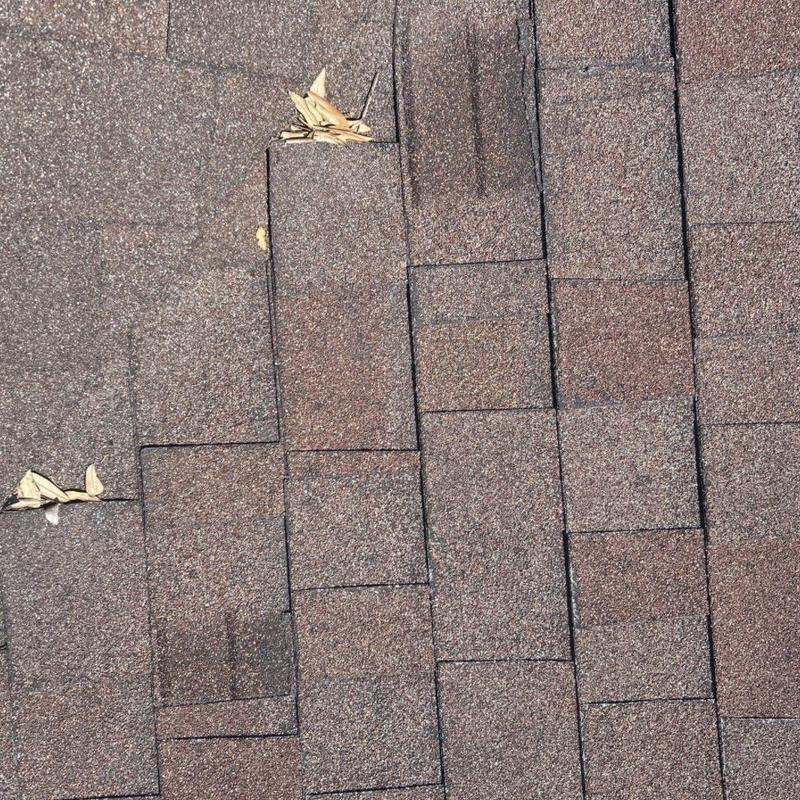 Shingle roof with damaged and missing shingles