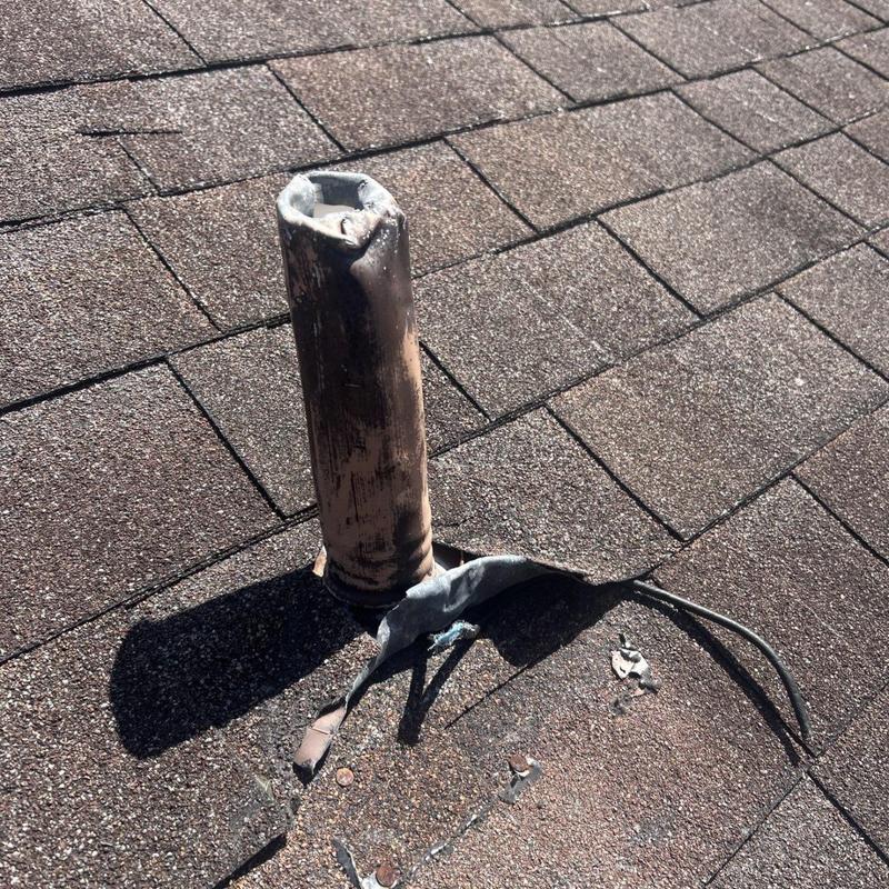 Roof vent pipe with damaged flashing on shingles