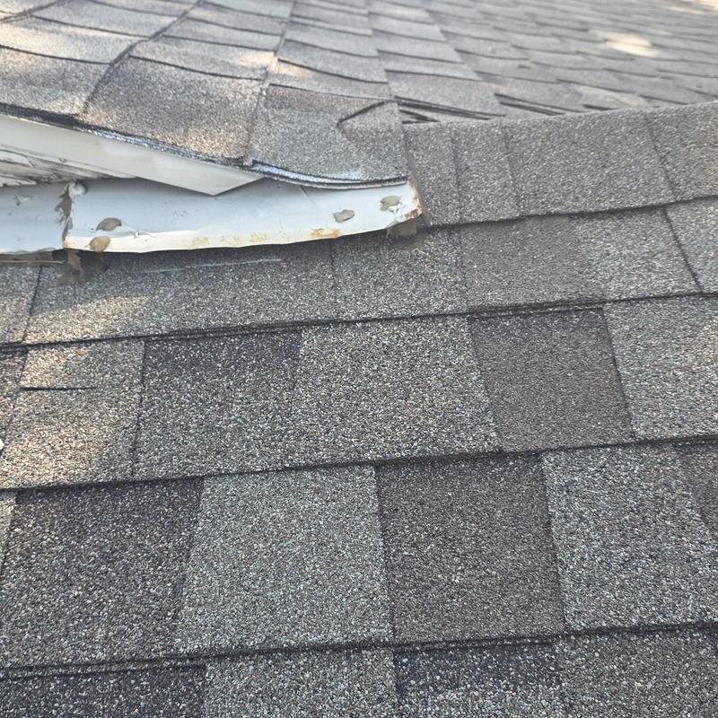 Asphalt roof shingles with hail and edge damage