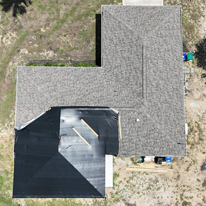 IKO Dynasty asphalt shingle roof under temporary dry-in membrane IKO Dynasty asphalt shingle roof under temporary dry-in membrane