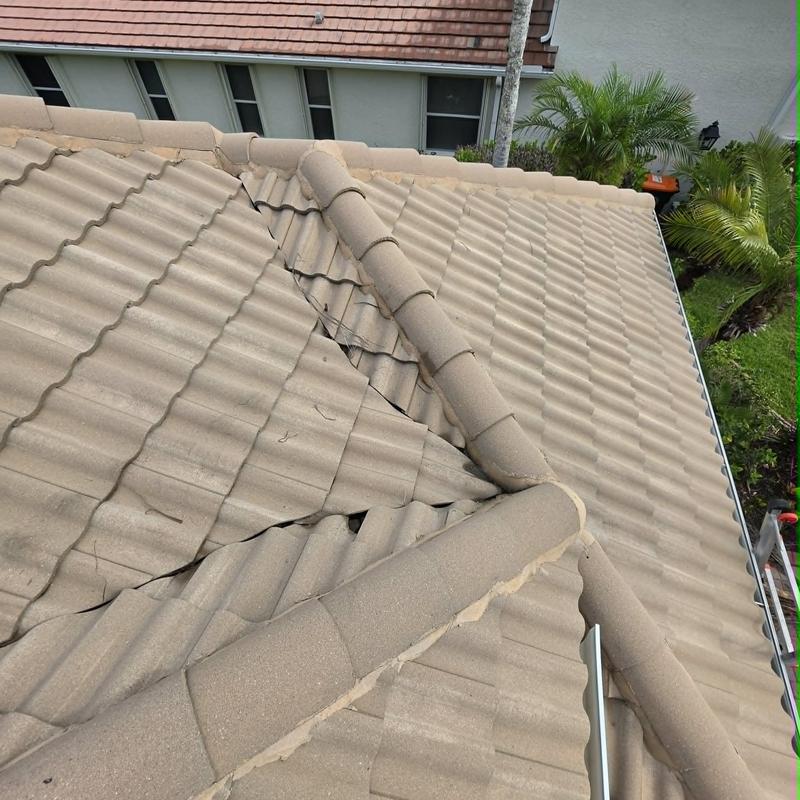 Damaged tile roof valley with displaced roof tiles Damaged tile roof valley with displaced roof tiles