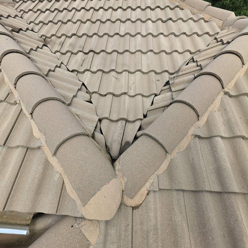 Tile roof valley with cracked and displaced tiles Tile roof valley with cracked and displaced tiles