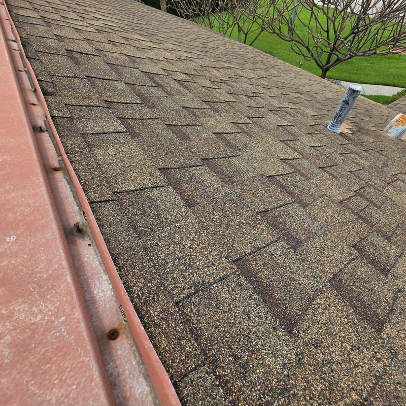Aging asphalt shingle roof with vent pipe and metal flashing Aging asphalt shingle roof with vent pipe and metal flashing