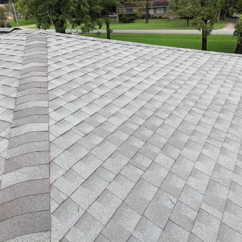 Grey asphalt shingle roof with ridge cap and vent flashing Grey asphalt shingle roof with ridge cap and vent flashing