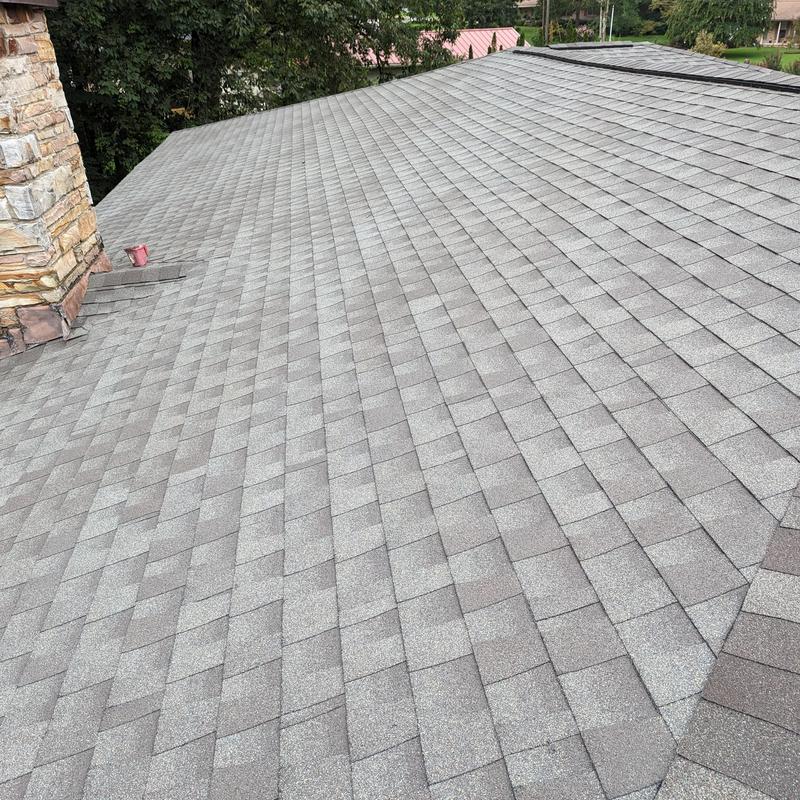 Grey asphalt shingle roof with new ridge cap and flashing Grey asphalt shingle roof with new ridge cap and flashing