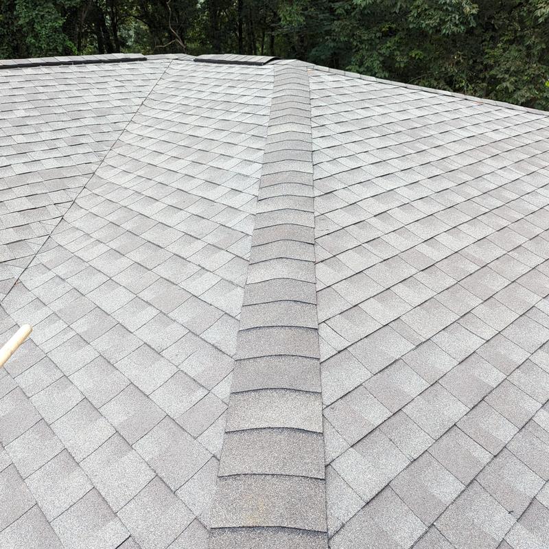 Grey asphalt shingle roof with ridge cap shingles Grey asphalt shingle roof with ridge cap shingles
