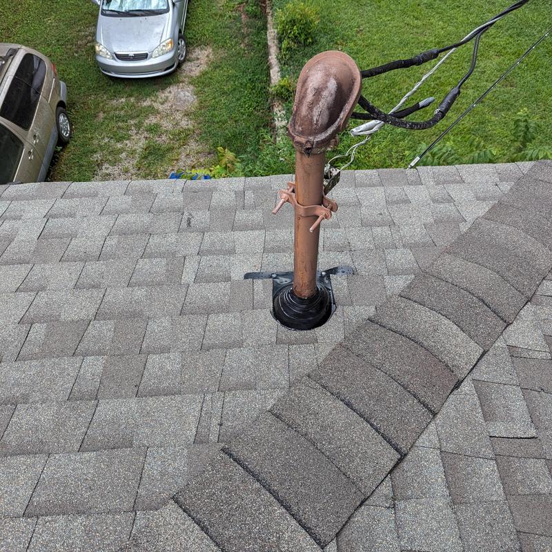 Asphalt shingle roof with vent pipe flashing and ridge cap Asphalt shingle roof with vent pipe flashing and ridge cap