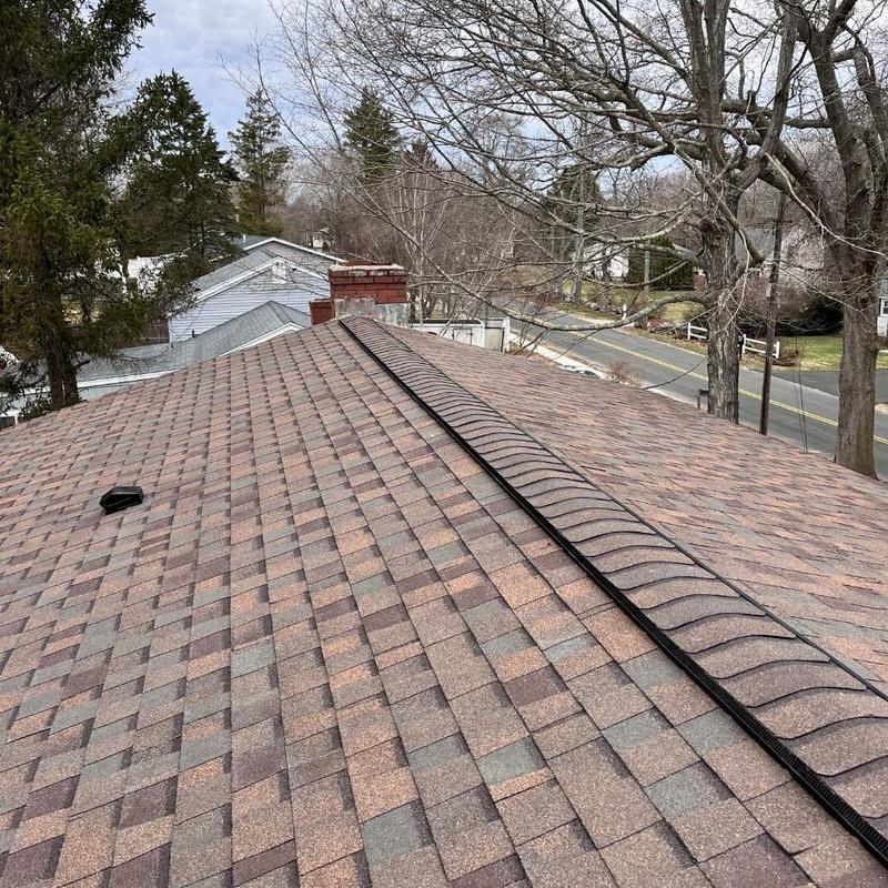 Asphalt shingle roof installation on residential home Asphalt shingle roof installation on residential home