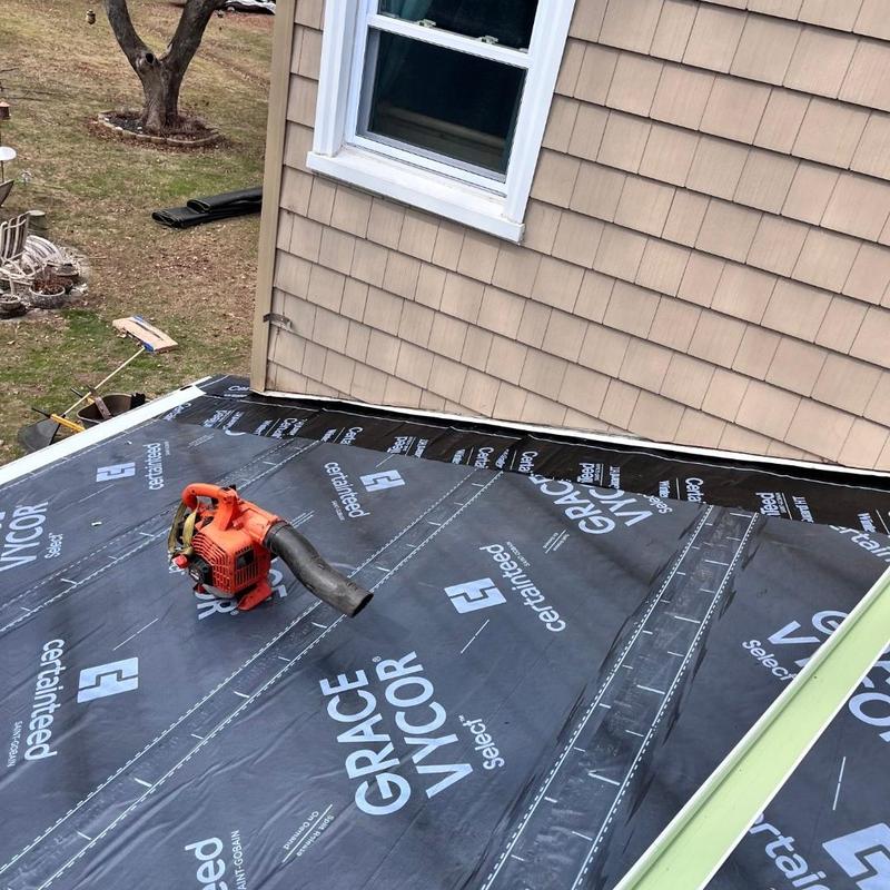 Roof underlayment installation on flat house extension Roof underlayment installation on flat house extension