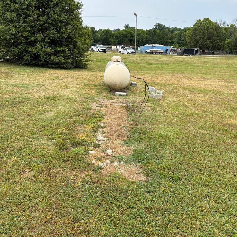 Propane tank installation site with exposed wiring