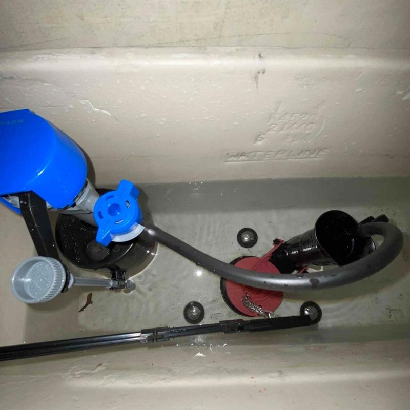 Toilet fill valve and flapper inside tank with water