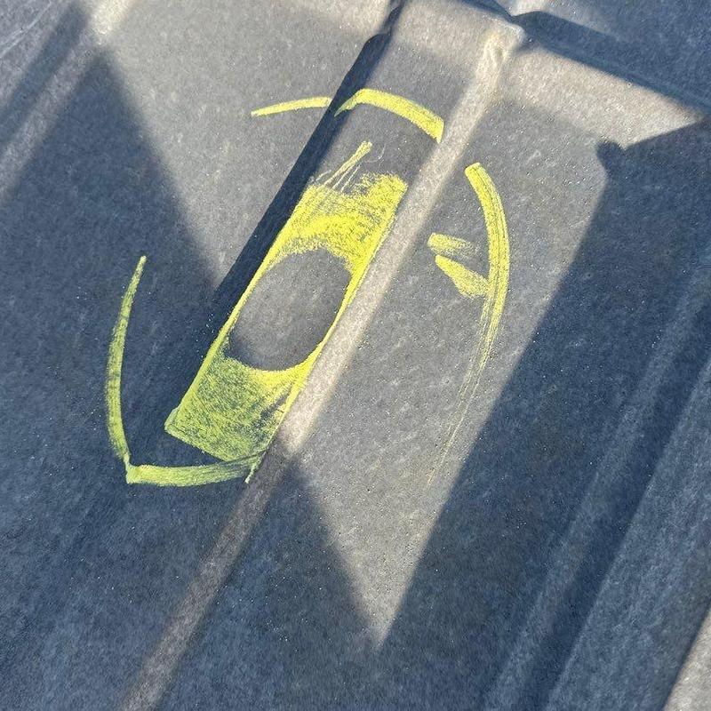 Metal roof hail damage marked with yellow chalk