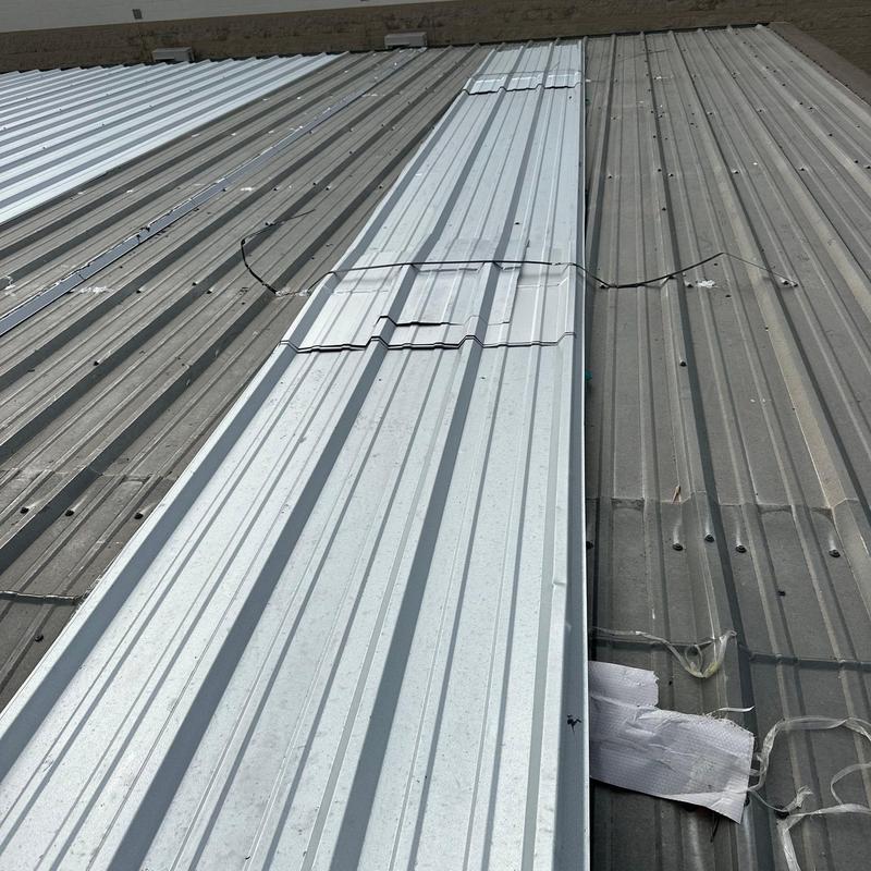 Metal roofing panels with hail damage and repairs