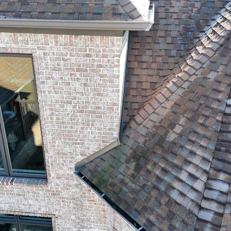 Asphalt shingle roof and flashing with hail damage