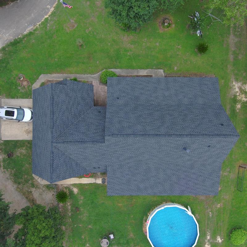 Charcoal shingle roof with black eave metal panels Charcoal shingle roof with black eave metal panels