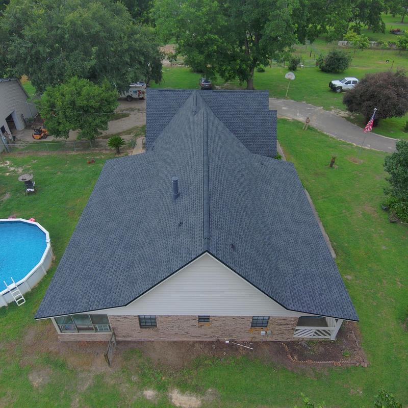 Charcoal shingle roof with black eave metal panels Charcoal shingle roof with black eave metal panels