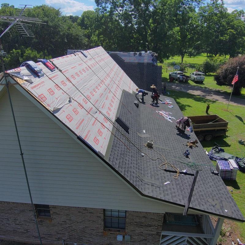 Charcoal shingle roof installation with black eave metal Charcoal shingle roof installation with black eave metal