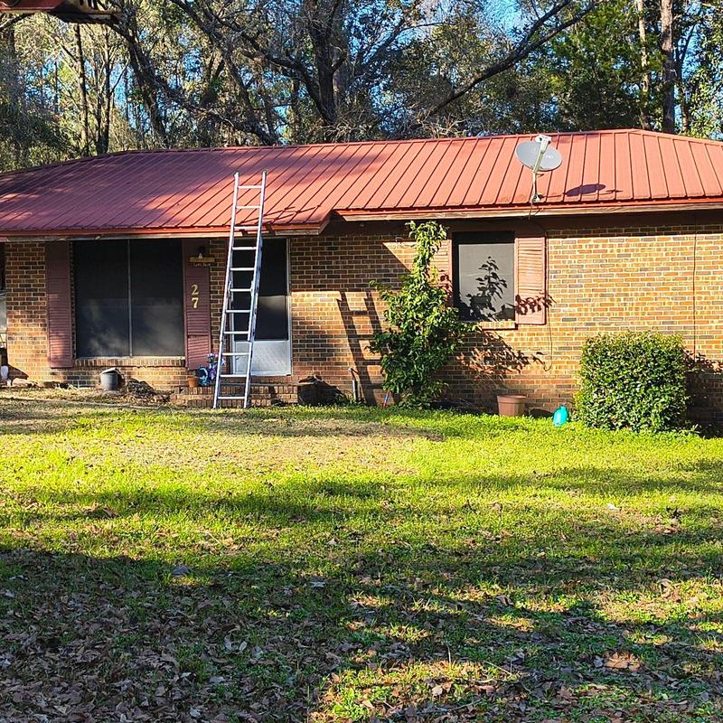 Metal roof with ladder for inspection in front yard