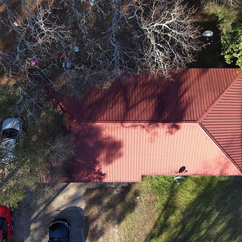 Metal roof with new panels under tree shadows