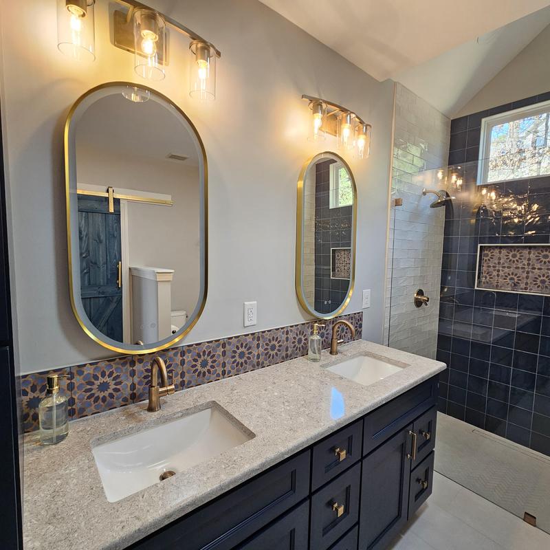 Bathroom double vanity with gold fixtures and tile backsplash Bathroom double vanity with gold fixtures and tile backsplash