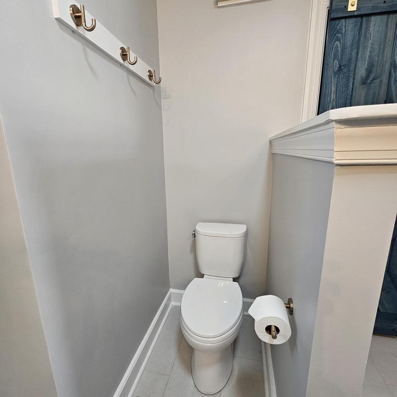 Toilet and wall hooks in narrow bathroom corner Toilet and wall hooks in narrow bathroom corner