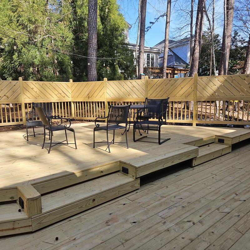 Wooden deck with tiered steps and fencing Wooden deck with tiered steps and fencing