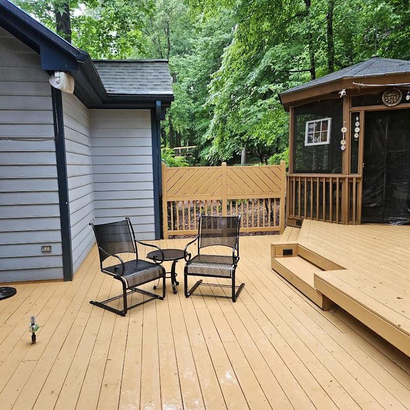 Wood deck with outdoor chairs and gazebo Wood deck with outdoor chairs and gazebo