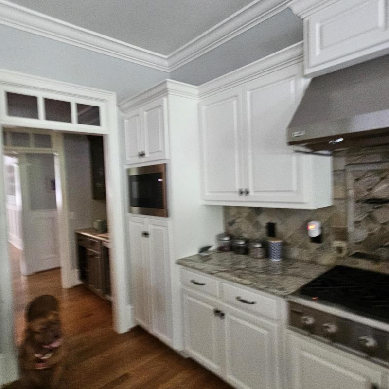 Kitchen cabinets and granite countertop with stove and vent hood Kitchen cabinets and granite countertop with stove and vent hood