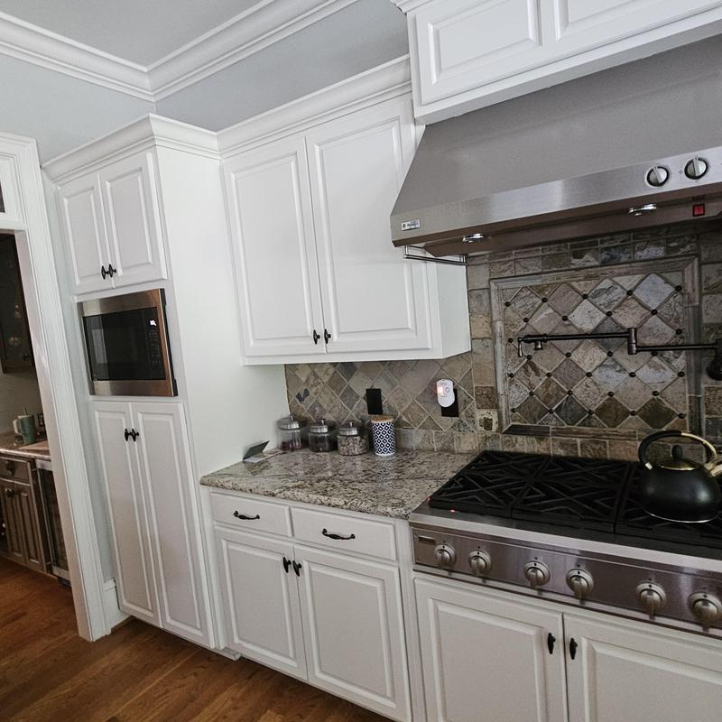 Gas cooktop and white kitchen cabinetry with granite counters Gas cooktop and white kitchen cabinetry with granite counters