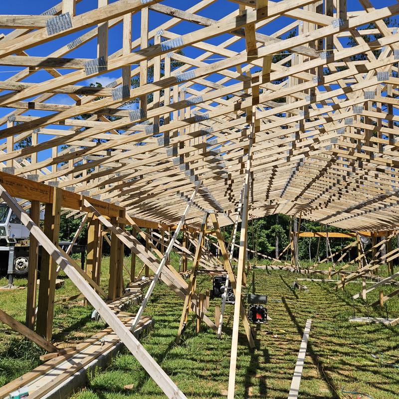 Wooden roof truss system framing under construction Wooden roof truss system framing under construction