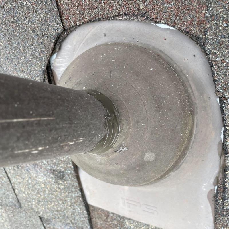 Pipe boot flashing sealed on shingle roof surface