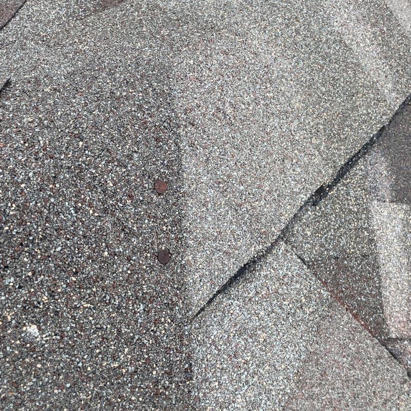 Roof shingles with exposed fasteners on roof surface
