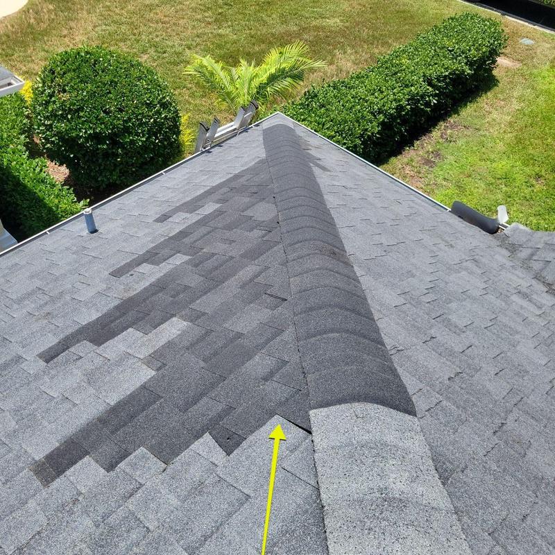 Owens Corning shingles with wind damage repair on roof ridge Owens Corning shingles with wind damage repair on roof ridge