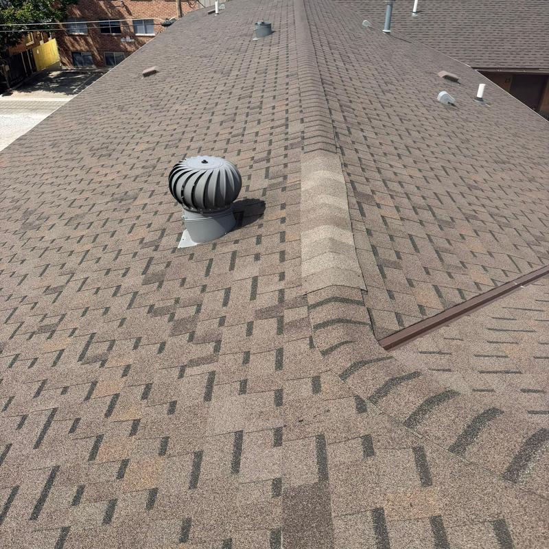 Whirlybird turbine vent on shingle roof ridge