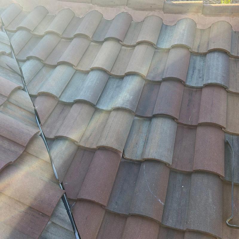 Concrete tile roof with adhesive crack repairs Concrete tile roof with adhesive crack repairs