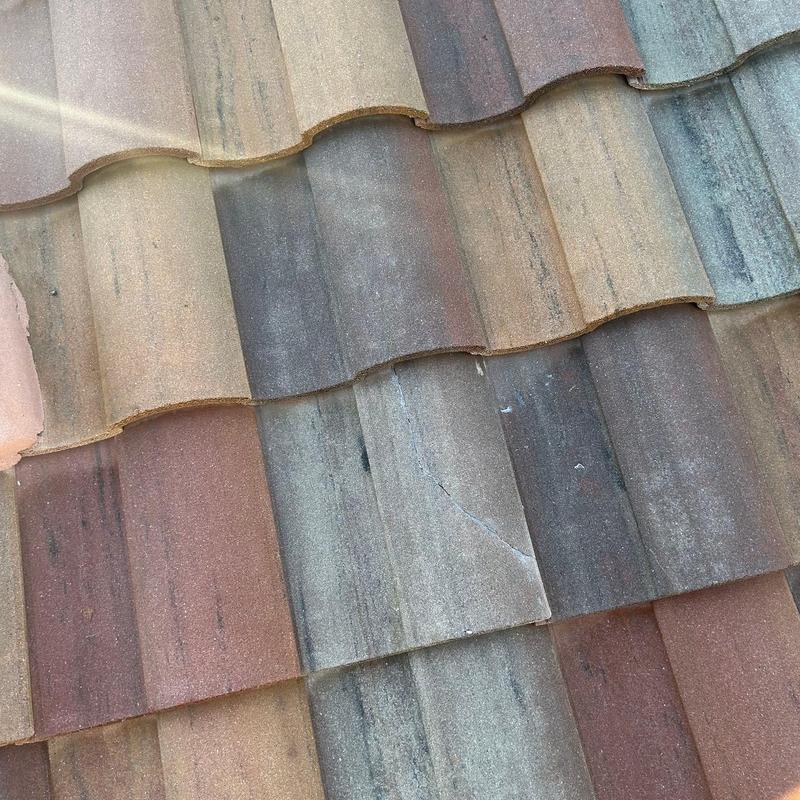 Concrete tile roof with cracked tile secured and sealed Concrete tile roof with cracked tile secured and sealed