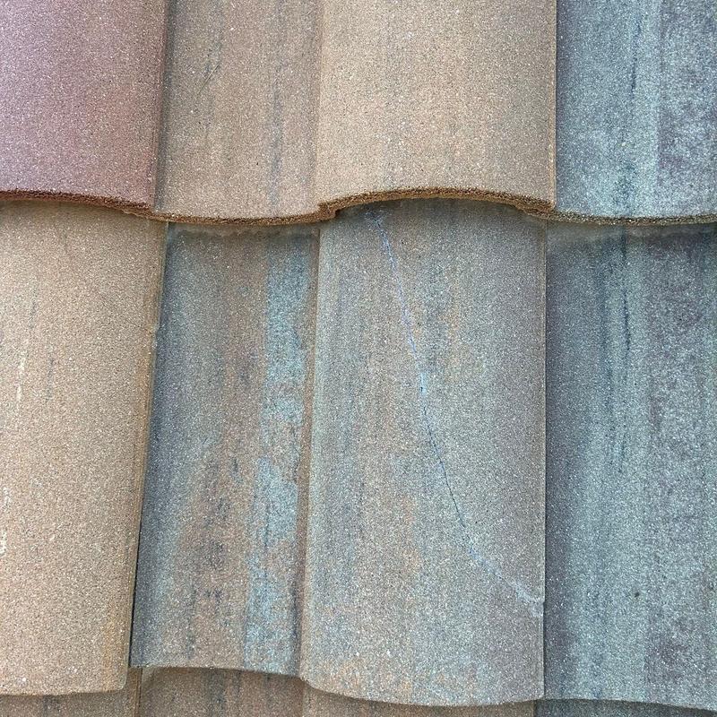 Concrete tile roof with adhesive-sealed crack Concrete tile roof with adhesive-sealed crack