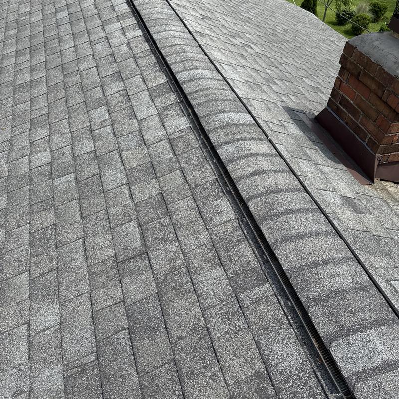 Asphalt shingle roof with chimney and ridge ventilation Asphalt shingle roof with chimney and ridge ventilation