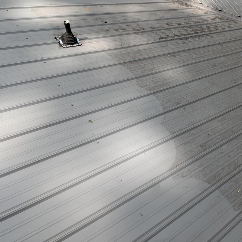 Metal roofing panels with sealed pipe penetration Metal roofing panels with sealed pipe penetration